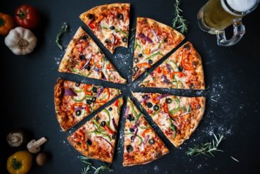 eating pizza - how to properly have a cheat day - toronto personal training